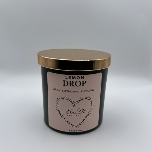 Soy candle in 8oz matte black glass jar with rose gold lid on white background.