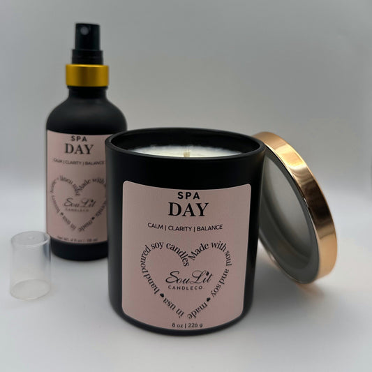 Air and linen mist in 4 oz matte black glass bottle with  gold neck and a Soy candle in 8oz matte black glass jar with rose gold lid off propped on the side of jar on white background. 
