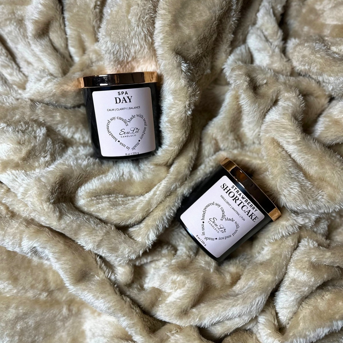 The Candle Duos Bundle includes two soy candles in 8oz matte black glass jars with rose gold lids on a textured beige background. 