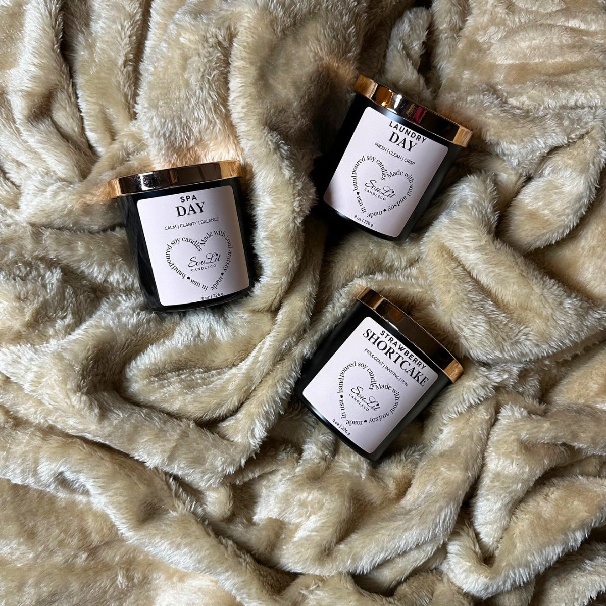 The Candle Trios Bundle includes three soy candles in 8oz matte black jars with rose gold lids on a textured beige background. 
