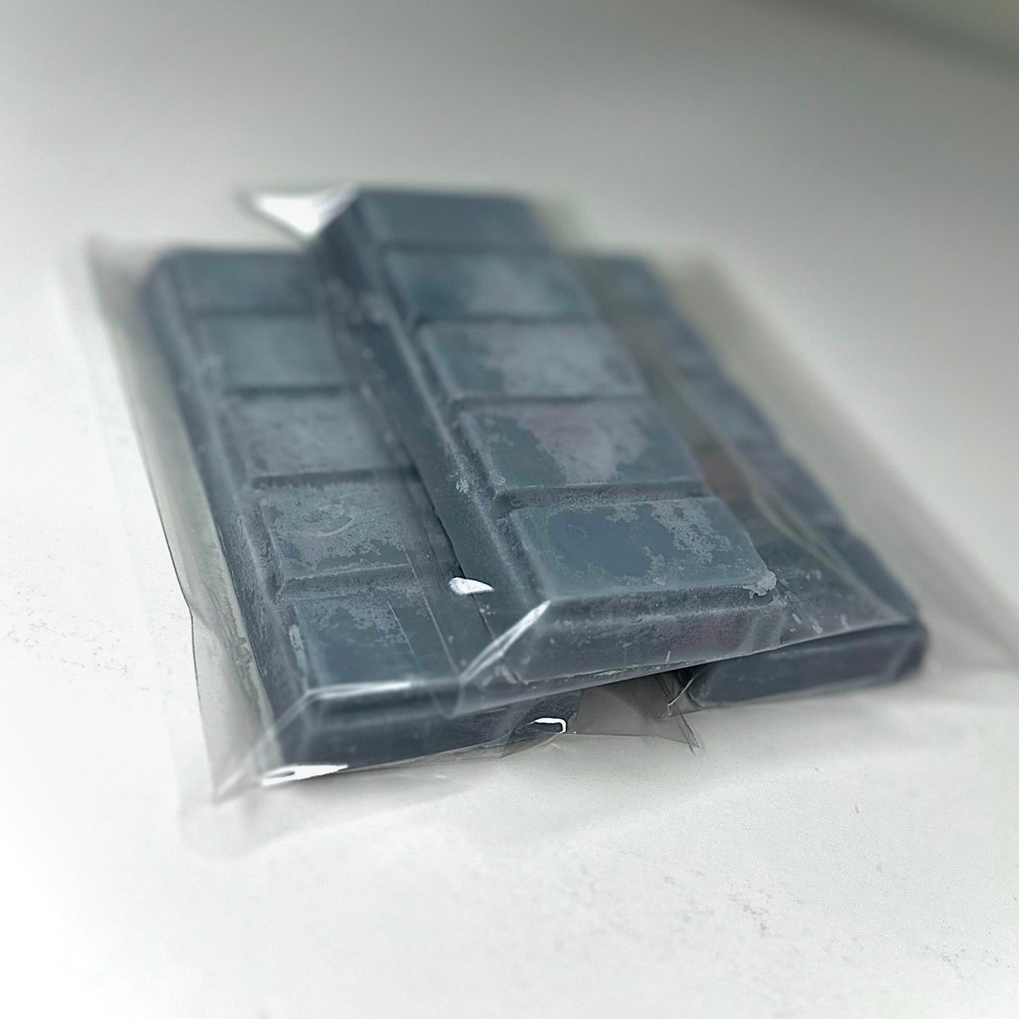 Three man of the hour (charcoal color) wax melt bars on white background. 