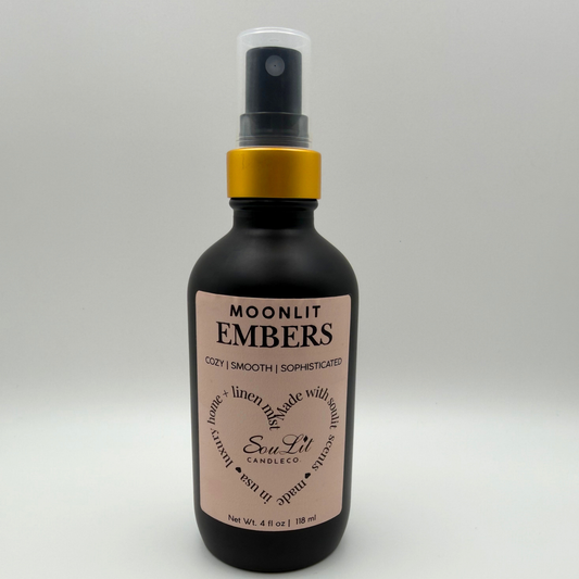 Air and linen freshener mist in 4oz matte black glass bottle with a gold neck and clear top on bottle