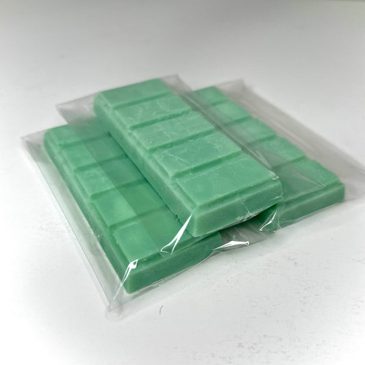Three spa day (green color) wax melt bars on white background. 