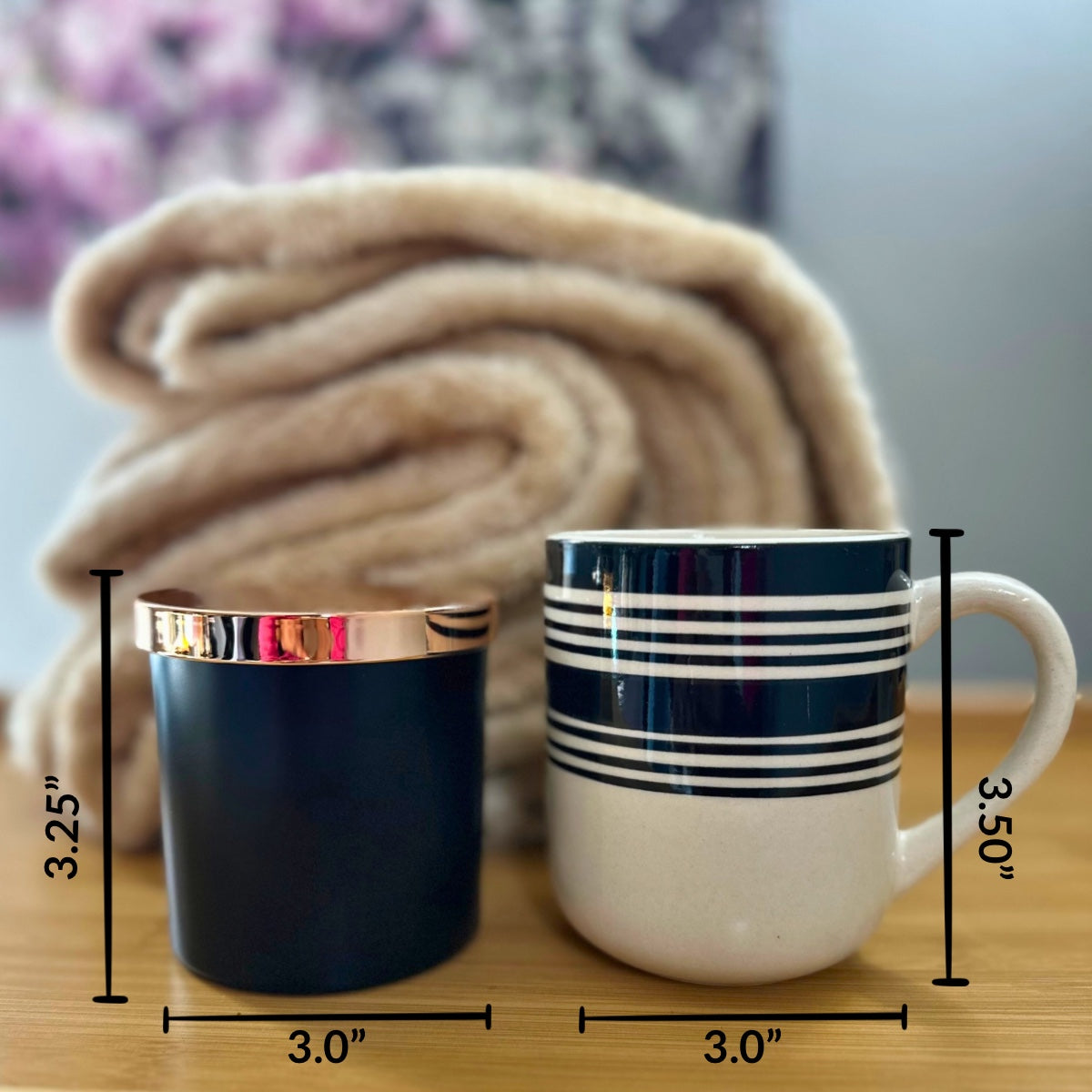 Reference photo comparing (height and weight) our matte black candle jar with rose gold lid to a black and white stripped coffee mug. 