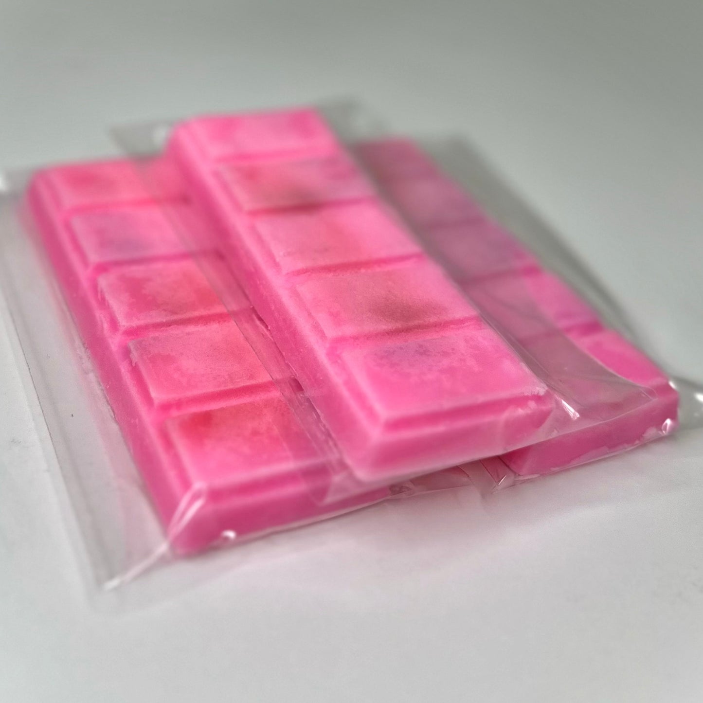 Three island punch (pink color) wax melt bars on white background. 