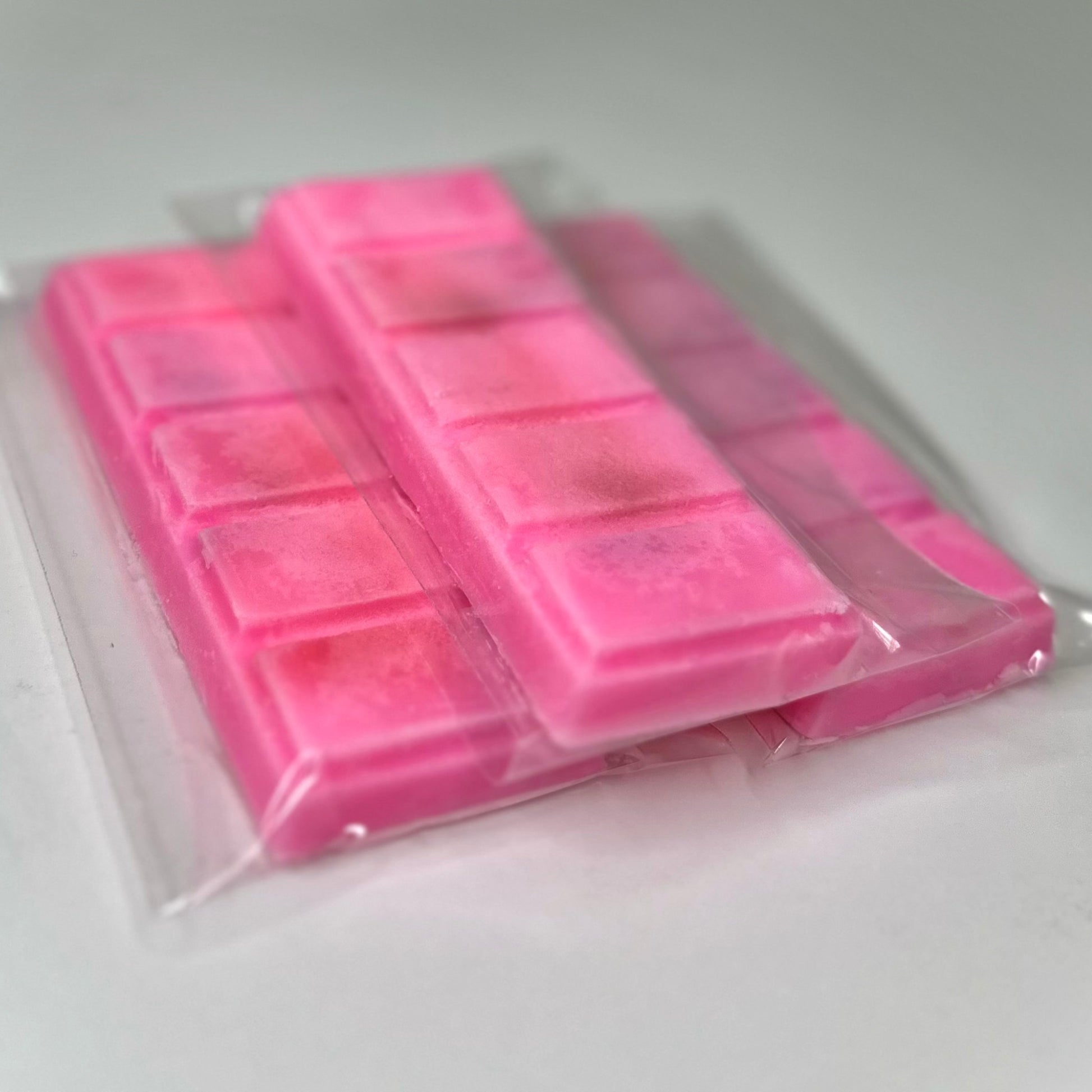 Three island punch (pink color) wax melt bars on white background. 