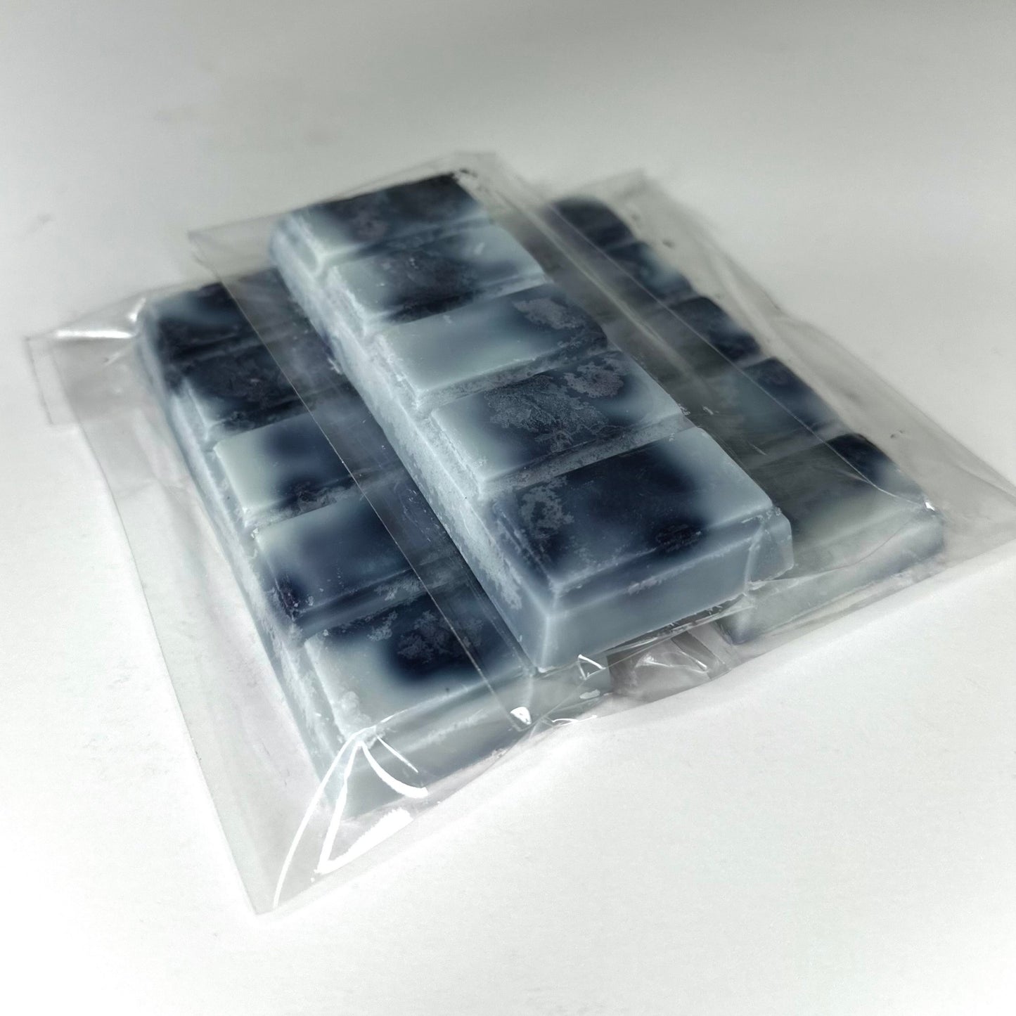 Three suit and tie (black, white, & gray abstract color) wax melt bars on white background. 